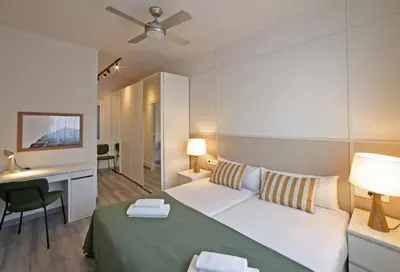 a bedroom with a white bed and a desk and a desk at Sagrada Familia - The Haus Bcn in Barcelona