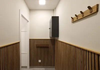 a hallway with a door and a television on a wall at Sagrada Familia - The Haus Bcn in Barcelona