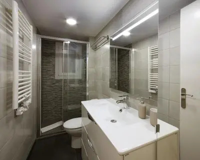 a bathroom with a white sink and a toilet at Sagrada Familia - The Haus Bcn in Barcelona