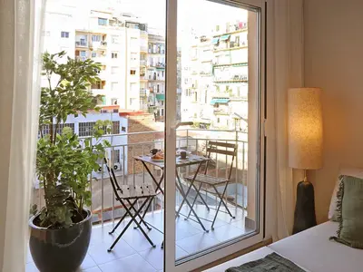 a room with a balcony with a table and chairs at Sagrada Familia - The Haus Bcn in Barcelona