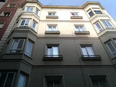 a tall building with windows on the side of it at Apartamentos Express by gaiarooms in Barcelona