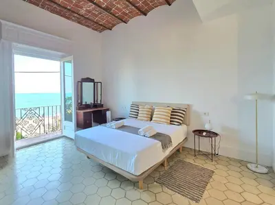a bedroom with a bed with a view of the ocean at Casa Mas Blau | Increíbles vistas frente al mar in San Pol de Mar