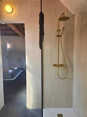 a bathroom with a shower with a glass door at Casa Mas Blau | Increíbles vistas frente al mar in San Pol de Mar
