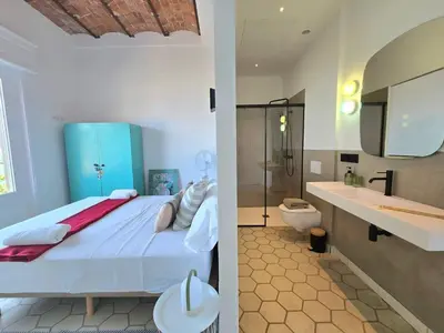 a bedroom with a bed and a bathroom with a toilet at Casa Mas Blau | Increíbles vistas frente al mar in San Pol de Mar