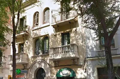 a building with balconies on the side of it at Barcelona Classic Eixample Apartments in Barcelona