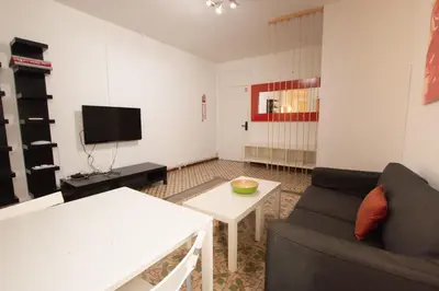a living room with a couch and a table at Barcelona Classic Eixample Apartments in Barcelona