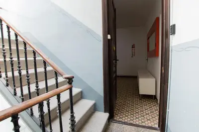 a hallway with stairs leading up to a room at Barcelona Classic Eixample Apartments in Barcelona