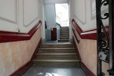 a stairway with stairs and a door in a building at Barcelona Classic Eixample Apartments in Barcelona