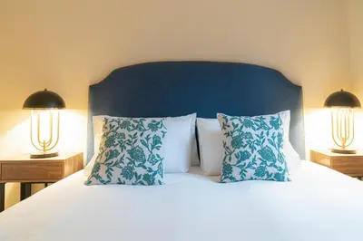 a bedroom with a bed with pillows and two lamps at Stay U-nique Apartment Putxet II in Barcelona