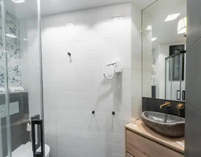 a bathroom with a sink and a glass shower at Stay U-nique Apartment Putxet II in Barcelona