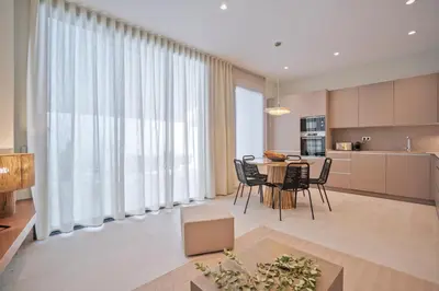a kitchen and living room with a table and chairs at Sitges Spaces Garden Condo-2 Bedrooms, 2 Bathrooms, Garden Terrace, Near center, Sleeps up to 6- Monthly Rentals Only in Sitges
