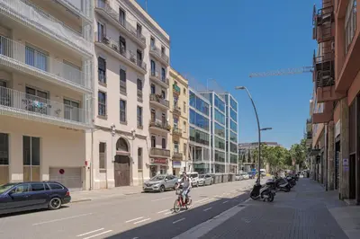 a person riding a bike down a city street at GuestReady - Lovely home in the heart of Barcelona in Barcelona