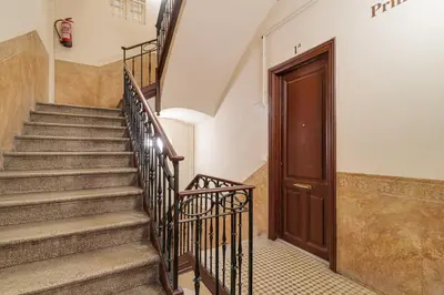 a staircase in a building with a wooden door at GuestReady - Lovely home in the heart of Barcelona in Barcelona