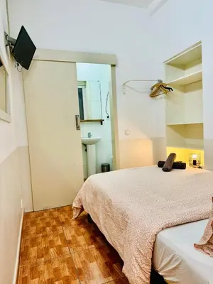 a bedroom with two beds and a television in it at O43 Center Barça 4 3 in Barcelona