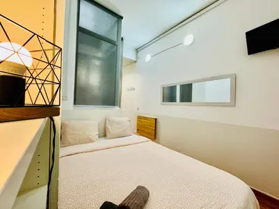 a bedroom with a bed and a window at O43 Center Barça 4 3 in Barcelona