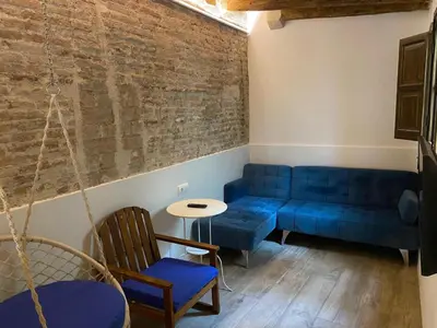 a living room with a blue couch and a table at Barcelona Classic Palau Apartments in Barcelona