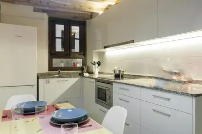 a kitchen with a table with blue plates on it at Barcelona Classic Palau Apartments in Barcelona