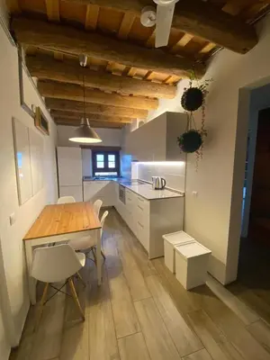a kitchen with a wooden table and white cabinets at Barcelona Classic Palau Apartments in Barcelona