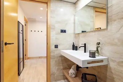 a bathroom with a white sink and a mirror at Cozy Apartment II - Les Corts in Barcelona
