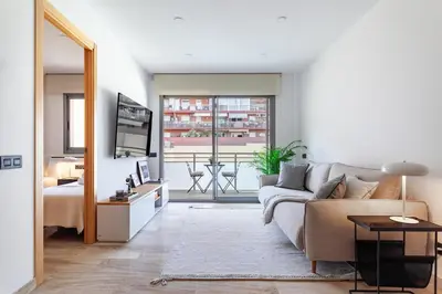 a living room with a couch and a table at Cozy Apartment II - Les Corts in Barcelona