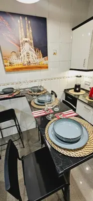 a table with plates on it in a kitchen at Apartamento exclusivo junto Sagrada Familia Barcelona in Barcelona