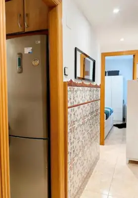 a kitchen with a refrigerator in a room at Mi casa es tu casa in Hospitalet de Llobregat