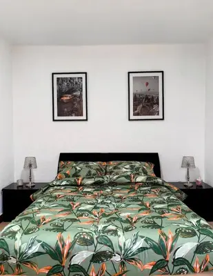a bedroom with a bed and two pictures on the wall at Mi casa es tu casa in Hospitalet de Llobregat