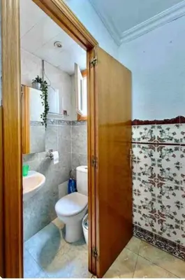 a bathroom with a toilet and a sink at Mi casa es tu casa in Hospitalet de Llobregat