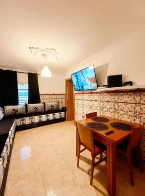 a living room with a table and a couch at Mi casa es tu casa in Hospitalet de Llobregat