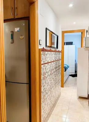 a kitchen with a stainless steel refrigerator in a room at Mi casa es tu casa in Hospitalet de Llobregat