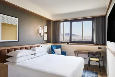 a hotel room with a bed and a desk and a window at Four Points by Sheraton Barcelona Airport in Barcelona