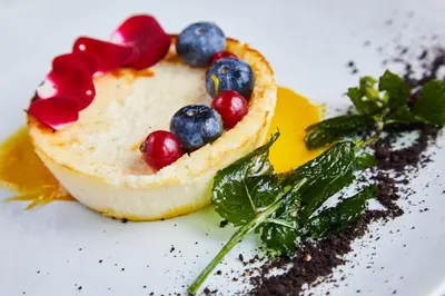 a dessert with fruit on a white plate at Four Points by Sheraton Barcelona Airport in Barcelona