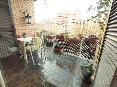 a balcony with a table and chairs on a patio at Spacious apartment in the heart of the city in Barcelona