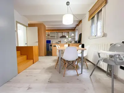 a kitchen with blue cabinets and a microwave at Duplex in Gracia in Barcelona