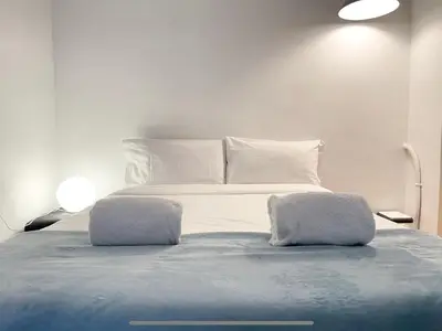 a bedroom with a bed with towels on it at Duplex in Gracia in Barcelona