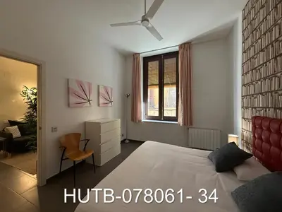 a bedroom with a large bed and a window at Palau de la música 1 in Barcelona