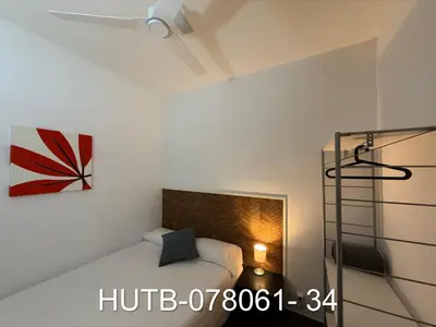 a bedroom with a bed and a painting on the wall at Palau de la música 1 in Barcelona