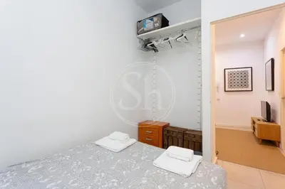 a bedroom with a bed and a mirror at Estudio en Gracia in Barcelona