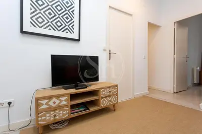 a television sitting on a table next to a door at Estudio en Gracia in Barcelona