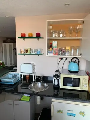 a kitchen with a counter top with a microwave at Apartamento con piscina y barbacoa cerca de Barcelona in Teià