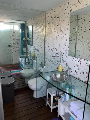 a bathroom with two toilets and a sink and a mirror at Apartamento con piscina y barbacoa cerca de Barcelona in Teià
