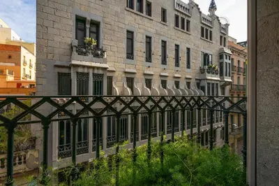 a building with a fence in front of a building at Happy Apartments in Barcelona