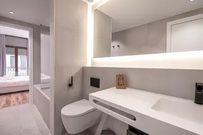 a white bathroom with a toilet and a sink at Happy Apartments in Barcelona