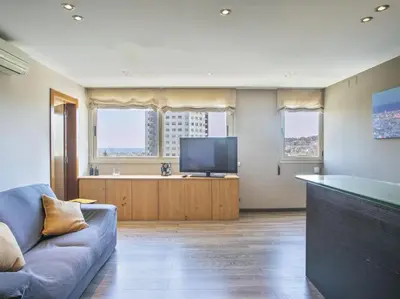 a living room with a couch and a flat screen tv at Apartamento temporal en Barcelona in Barcelona