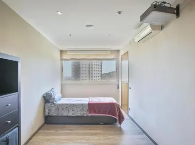 a bedroom with a bed with a yellow blanket on it at Apartamento temporal en Barcelona in Barcelona