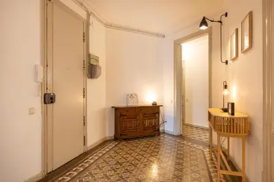 a hallway with a table and a wooden cabinet at B41 - Apartamento para grandes grupos en BCN centro in Barcelona