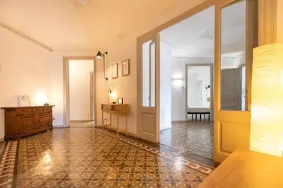a hallway with a door and a room with a table at B41 - Apartamento para grandes grupos en BCN centro in Barcelona