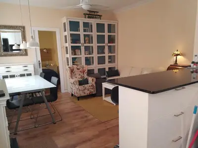 a kitchen and living room with a counter and a table at Apart 2 bedrooms 2 bathroom 30 nigth min WiFi washmachime elevator AC heather in Barcelona