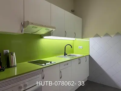 a green and white kitchen with a sink at Palau de la música 2 in Barcelona