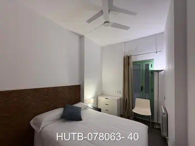 a bedroom with a bed and a chair in it at Palau de la música 3 in Barcelona